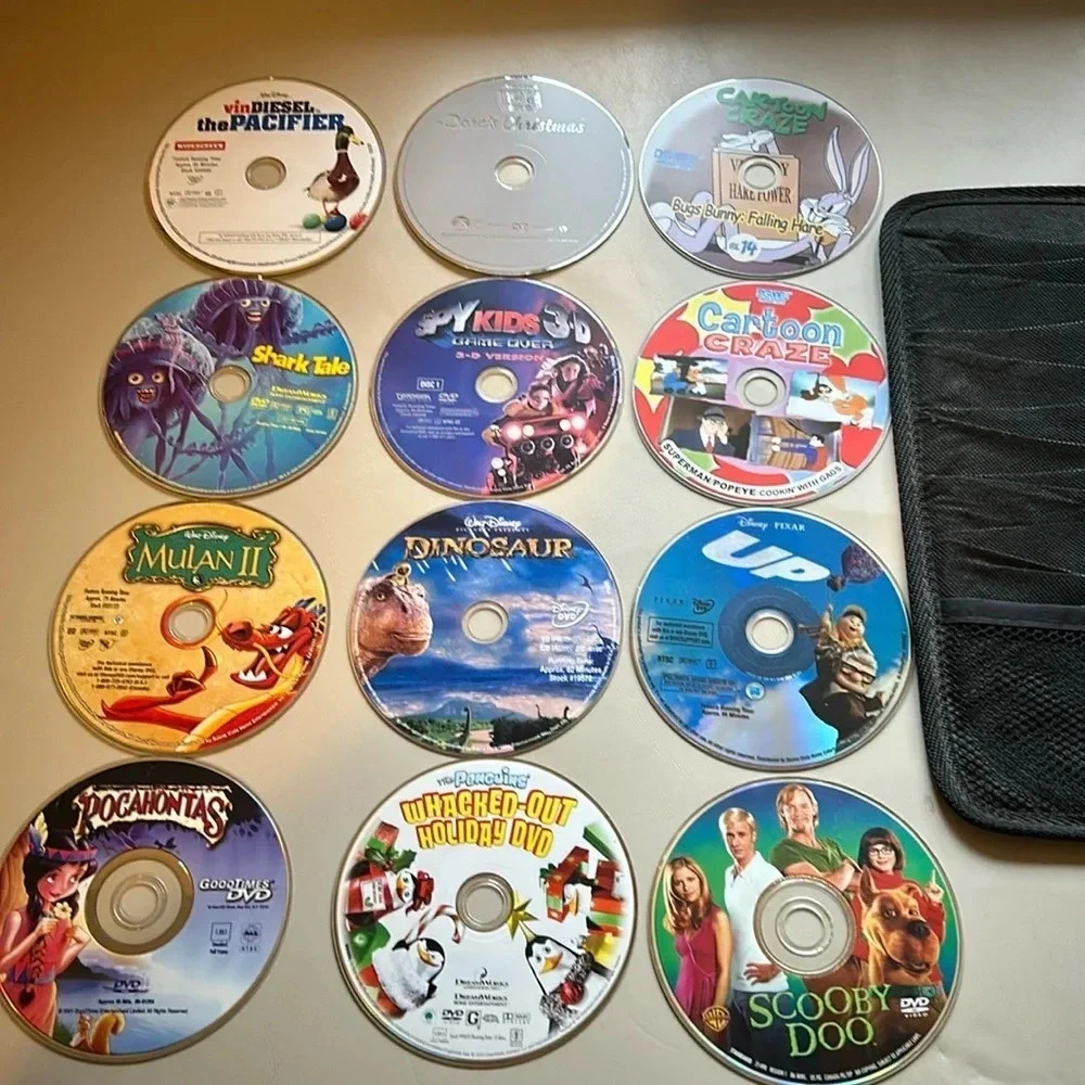 12 Random CD Movies with travel case most are probably vintage for 1 price